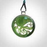 A hand carved New Zealand Jade and Sterling Silver Octopus pendant with Opal eye. Hand made by New Zealand artist Kerry Thompson.